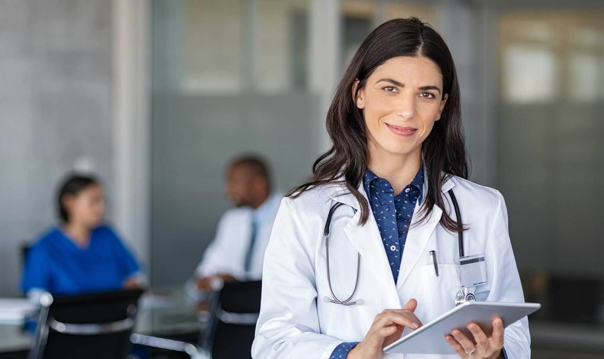 Doctor-holding-digital-tablet-at-meeting-room